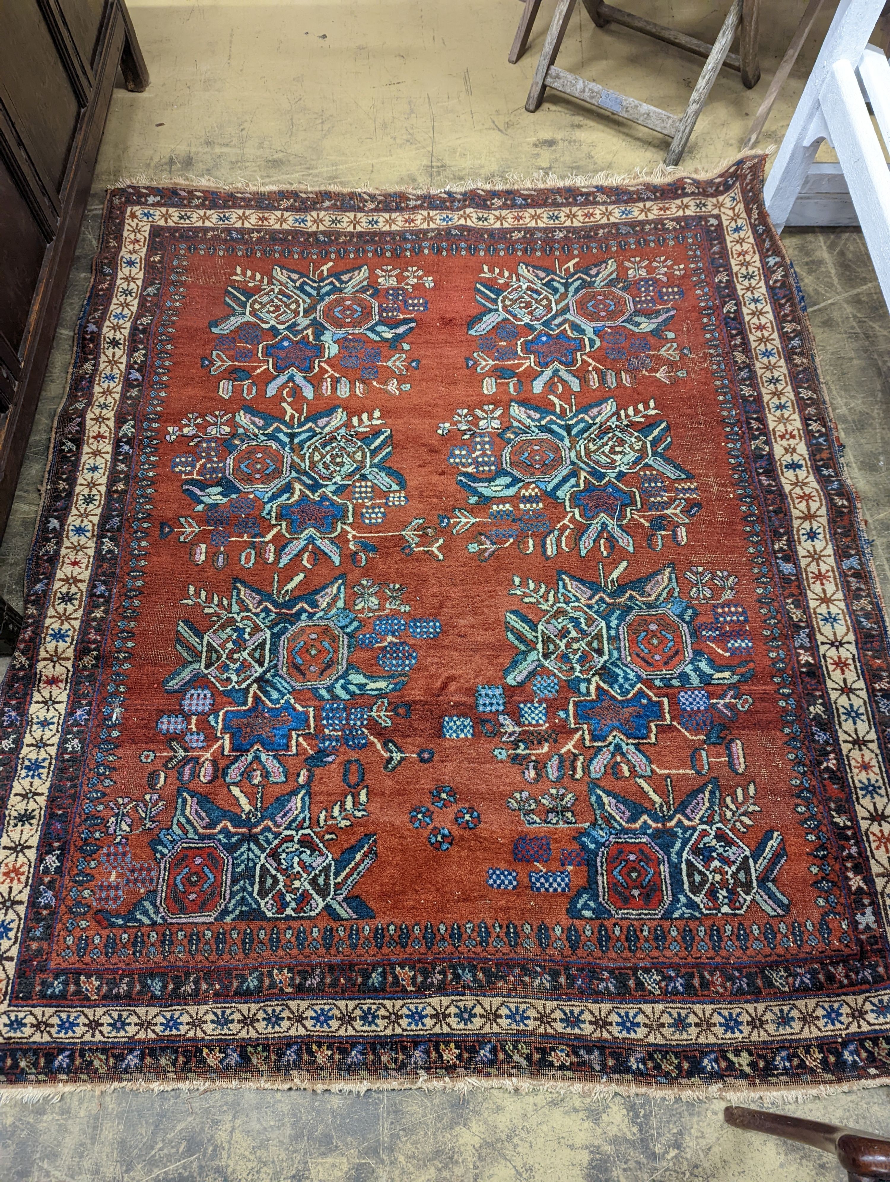 A North West Persian red ground rug with stylised foliate motifs, 185 x 157cm